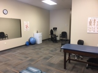 Treatment room at Battle Mountain Physical Therapy with a treatment table and exercise equipment